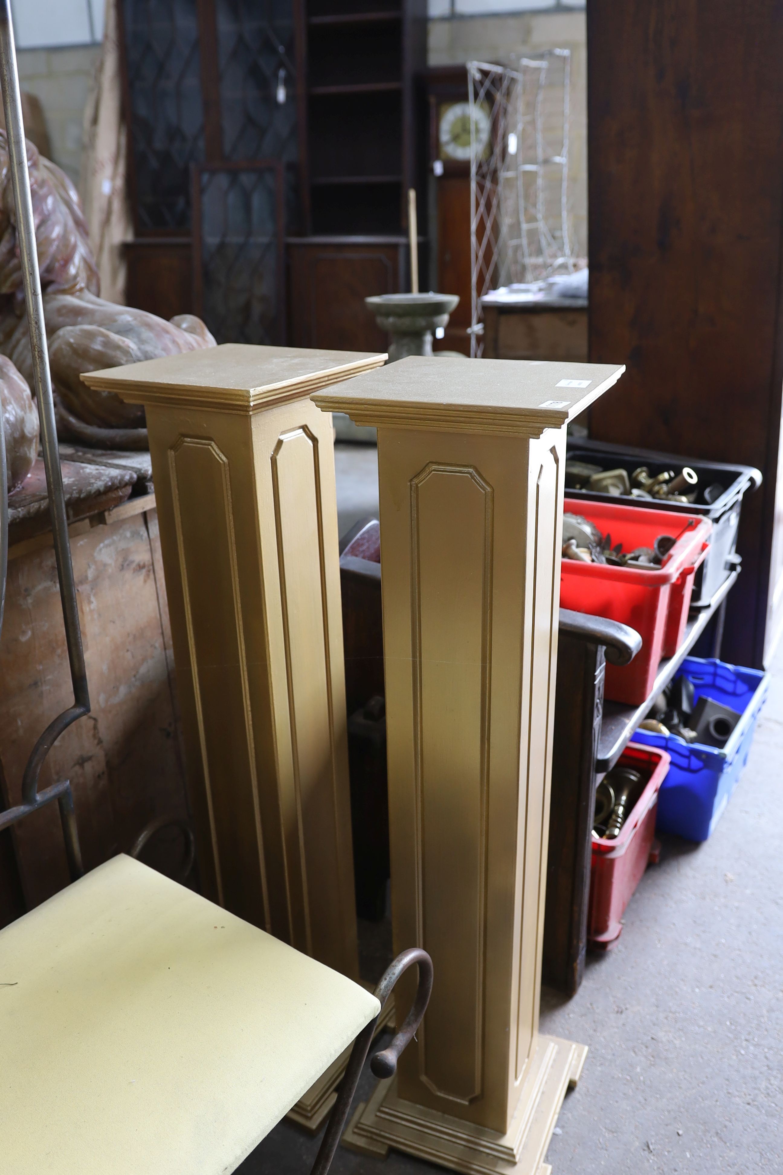 A pair of gold painted pedestals, height 108cm